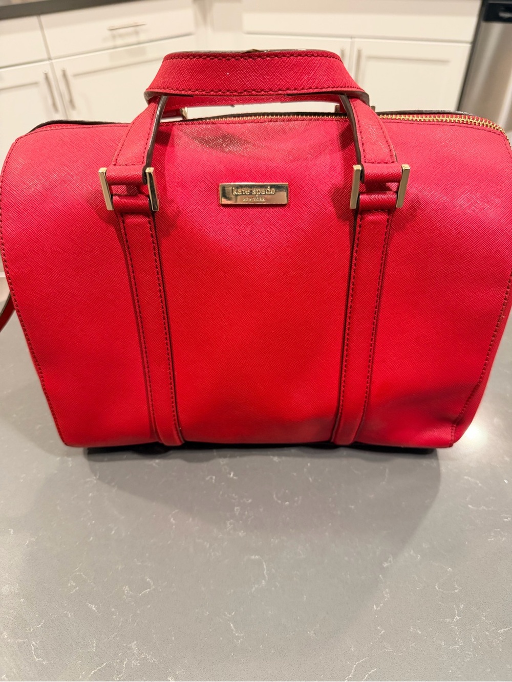 kate spade red leather satchel with gold-tone plaque